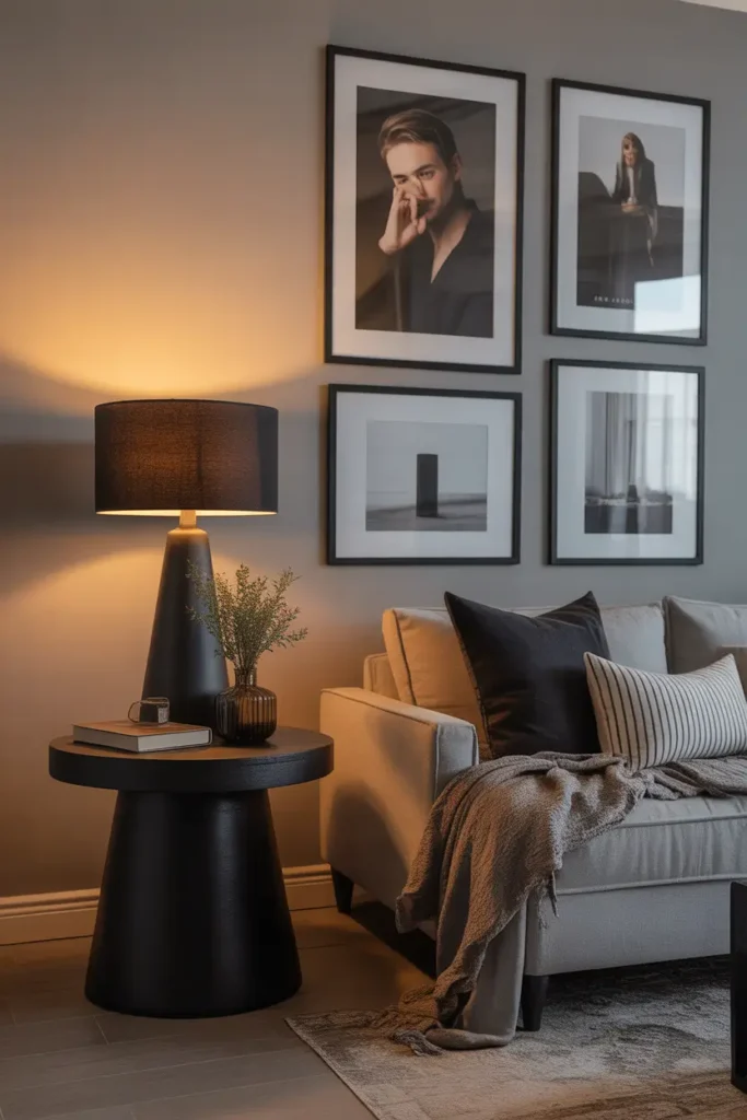 Modern apartment interior with matte black decor accents including lamp, frames, and side table details, neutral color palette, warm ambient lighting, cozy masculine styling, Pinterest inspired realistic photography, soft shadows, balanced textures, contemporary urban apartment feel with calm atmosphere and stylish minimal design composition.