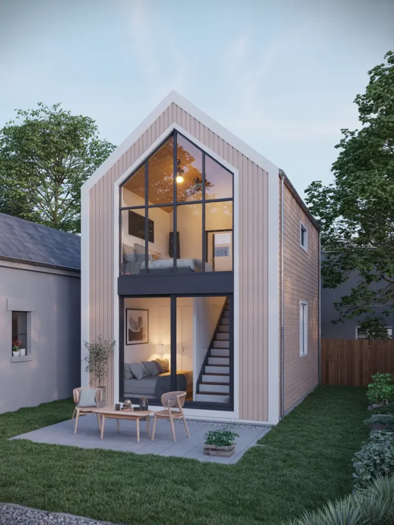 Modern detached garage apartment in a tiny backyard with a vertical loft layout, soft beige exterior, black-framed windows, slim staircase, warm lighting, compact outdoor patio, natural wood accents, minimal landscaping, Scandinavian-inspired design, cozy upper sleeping loft, bright open interior visible through windows, clean architecture, peaceful suburban setting, realistic photography style, soft daylight, elegant small-space styling